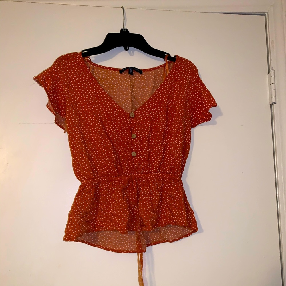 Orange and white polka dot top